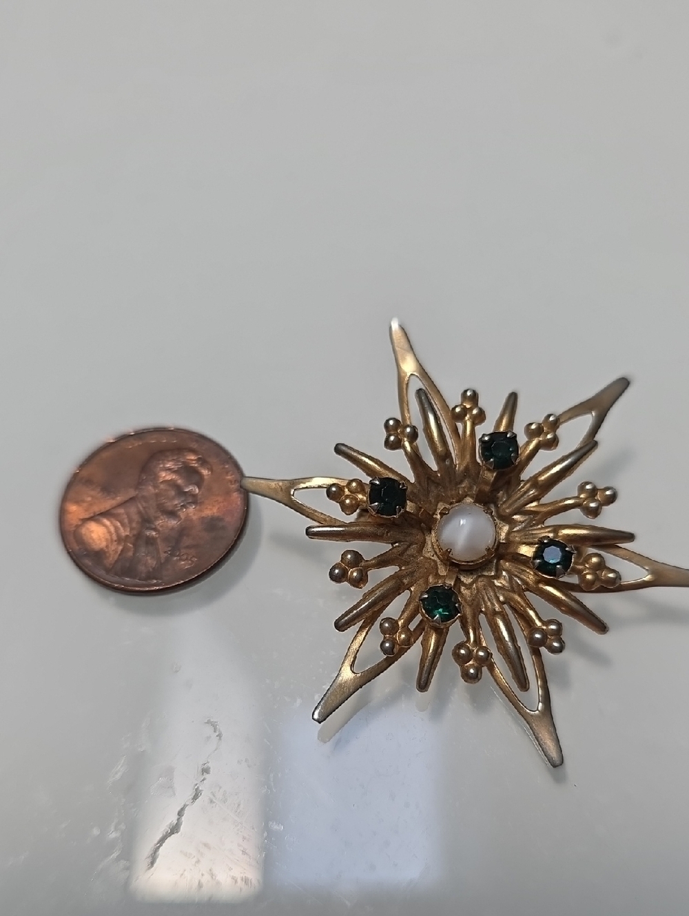 Gold-Tone Starburst Brooch with Green Stones and Pearl Accent